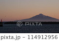 View of the sea at dusk, the lighthouse and Rishiri Island. 114912956
