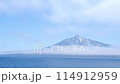 Rishiri Island appears to be floating with clouds hanging over the foot of the mountain. An island in the sky. 114912959