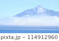 Rishiri Island appears to be floating with clouds hanging over the foot of the mountain. An island in the sky. 114912960