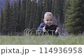 Baby boy playing outside on green grass in lush Canadian Nature. 114936958