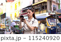 Young Asian woman having low signal on her mobile phone while travelling in Bangkok, Thailand 115240920