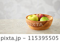 Bright apples and the shadows of sunlight filtering through the trees 115395505
