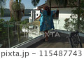 Asian woman in silk robe is relaxing breakfast on the big private terrace 115487743