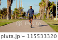 Sportsman running through the streets of the city, holding a bottle of water. 115533320
