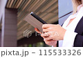 Unrecognizable beautiful business woman with a digital tablet outdoors. 115533326