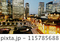 Tokyo twilight lit up skyscrapers surrounding Tokyo Station time lapse zoom in 115785688