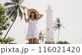 Woman Taking Selfie at Galle Fort Lighthouse in Sri Lanka 116021420