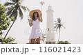 Woman Video Calling at Galle Fort Lighthouse in Sri Lanka 116021423