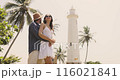 Happy Couple Embracing at Galle Fort Lighthouse in Sri Lanka 116021841