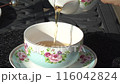 pouring tea into cup of tea 116042824