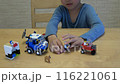boy playing crazy with Lego 116221061
