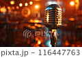 Retro microphone on a stage with a golden bokeh 116447763