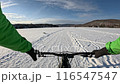 Fat Biking Across a Frozen Lake in Winter Wonderland - Scenic Adventure Cycling Experience. Exploring Frozen Lake Trails on a Fat Bike - Thrilling Winter Ride in Snowy Landscape. 116547547