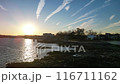 The sky is blue and the sun is setting 116711162
