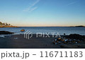 A calm lake with a boat in the water 116711183