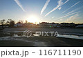 A beach with a house in the background 116711190