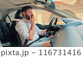 handsome caucasian man driving car in the city on summer day 116731416