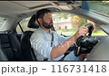 handsome caucasian man driving car in the city on summer day 116731418