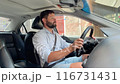 handsome caucasian man driving car in the city on summer day 116731431