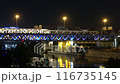 The scyscrapers of the Moscow City at night and the Dorogomilovsky bridge with illumination. Moscow, Russia - urban background. Translation of text - street names: Krasnopresnenskaya, center, etc. 116735145