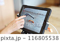 A woman examines a part on a tablet for printing on a 3D printer. 116805538