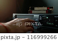 Removing the VHS tape from the VCR. 116999266