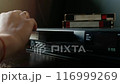Loading a video cassette into a VCR. 116999269