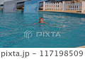 Teenager swimming in pool, enjoying fun summer day sports and recreation concept 117198509