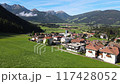 This is a picturesque and scenic mountain village that is surrounded by lush, vibrant green fields 117428052
