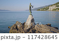 A bronze statue overlooks the Adriatic Sea in a coastal town, offering a peaceful view 117428645