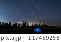 Time Lapse of Milky Way Moving over blue Glowing Tent. Night Starry Sky  117459258