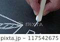 A hand draws a chart on a board with chalk. Planning and education. 117542675
