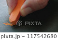 Close-up of an orange chalk drawing on a board. Creativity and expression. 117542680