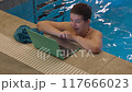 Woman Smiling with Laptop in Swimming Pool 117666023
