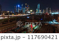 Time-lapse of night traffic with a view of subway trains and cars with headlights 117690421