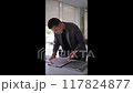Young Asian businessman writing and researching documents 117824877