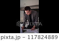 Young Asian businessman typing work information on his laptop at the work desk.  117824889