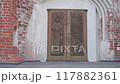 Wooden door in a brick building 117882361