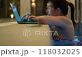 Woman Checking Laptop While in Swimming Pool 118032025