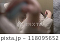 Woman combing her hair in front of mirror. Concept of health care and morning routine 118095652