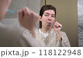 Woman brushing braces teeth by orthodontic brush. Female cleaning oral brackets. 118122948