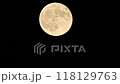 Yellow full harvest moon on a black night sky background 118129763