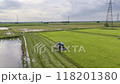 07,09,2024 Lopburi, Thailand, Thai farmers harvest their crops using a modified tractor equipped with rice harvesting machinery in a rice field in Thailand. 118201380
