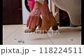 Woman picking up a tampon from the floor, wearing suede high heels and pink underwear in a beige-toned bathroom during menstruation 118224511