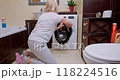 Beginning Laundry Routine in a Warm, Inviting Bathroom 118224516