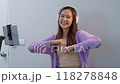 Asian women and beautiful bloggers wear headphones dancing videos by smartphone cameras. Creator vlogger talent dancing enjoys hobby content recording show video sharing on social media. 118278848