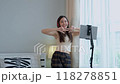 Asian women and beautiful bloggers wear headphones dancing videos by smartphone cameras. Creator vlogger talent dancing enjoys hobby content recording show video sharing on social media. 118278851