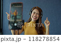 Asian women and beautiful bloggers wear headphones dancing videos by smartphone cameras. Creator vlogger talent dancing enjoys hobby content recording show video sharing on social media. 118278854