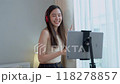 Asian women and beautiful bloggers wear headphones dancing videos by smartphone cameras. Creator vlogger talent dancing enjoys hobby content recording show video sharing on social media. 118278857