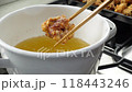 Fried chicken, chopsticks lifted from oil (slow motion) 118443246